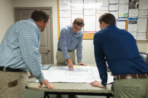 group of dedicated epoxy coating specialists planning floor repair in Kansas City